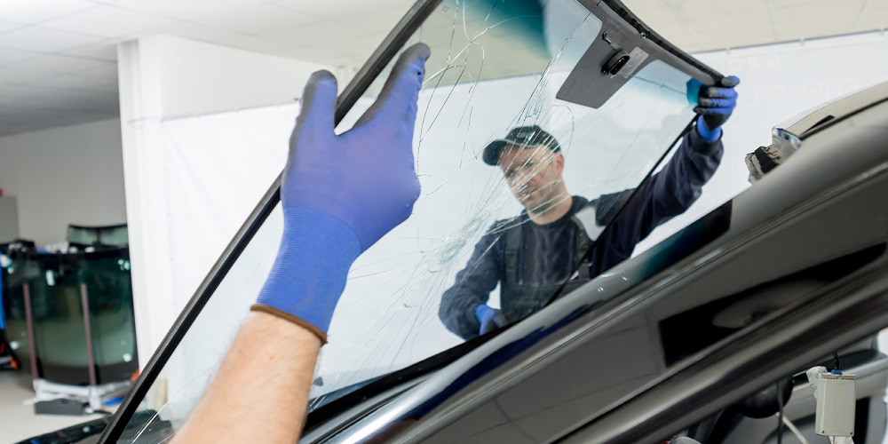 Photo of Staff Removing Broken Windshield from the car